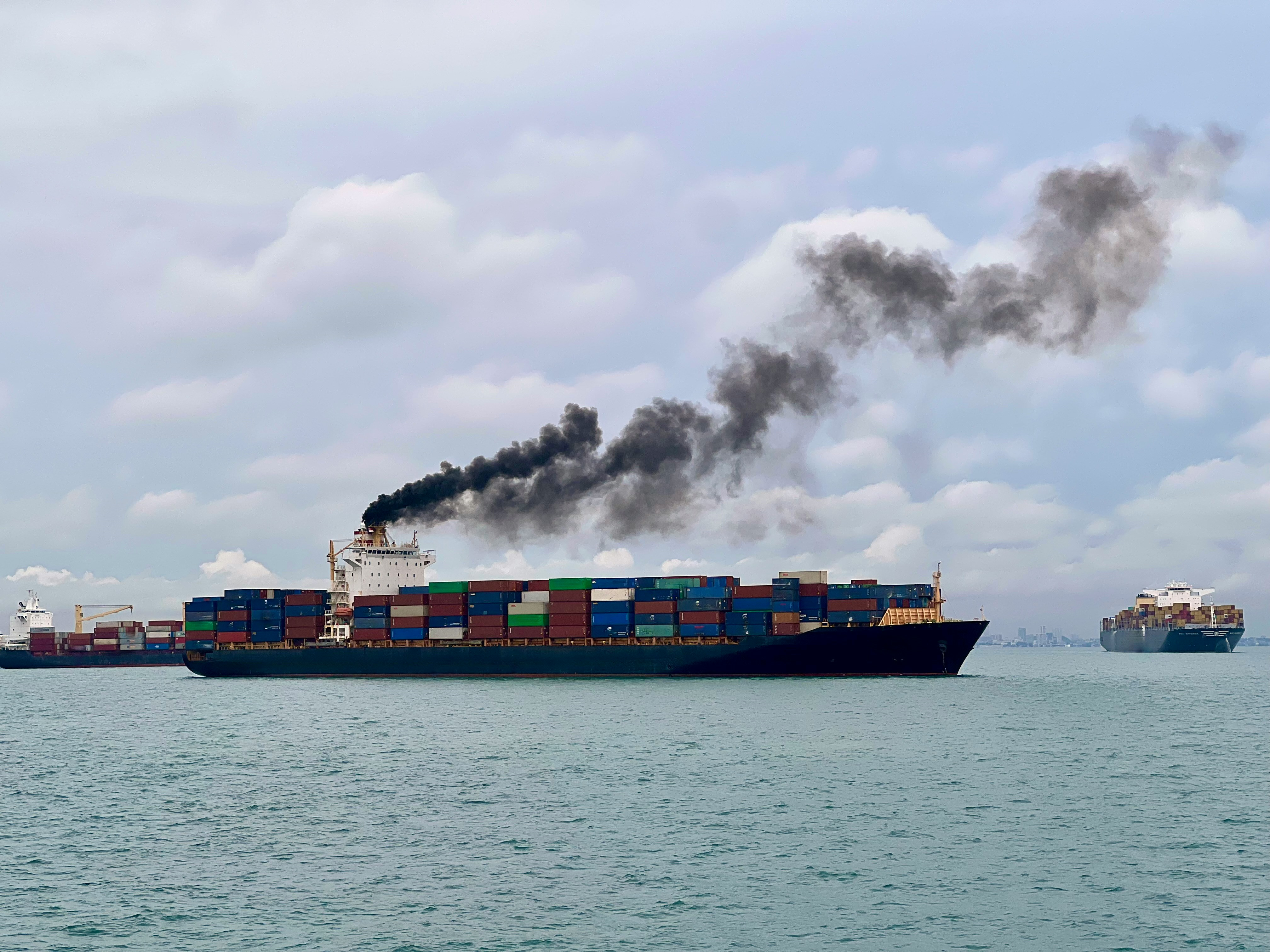 Background image of a ship loaded with shipping containers